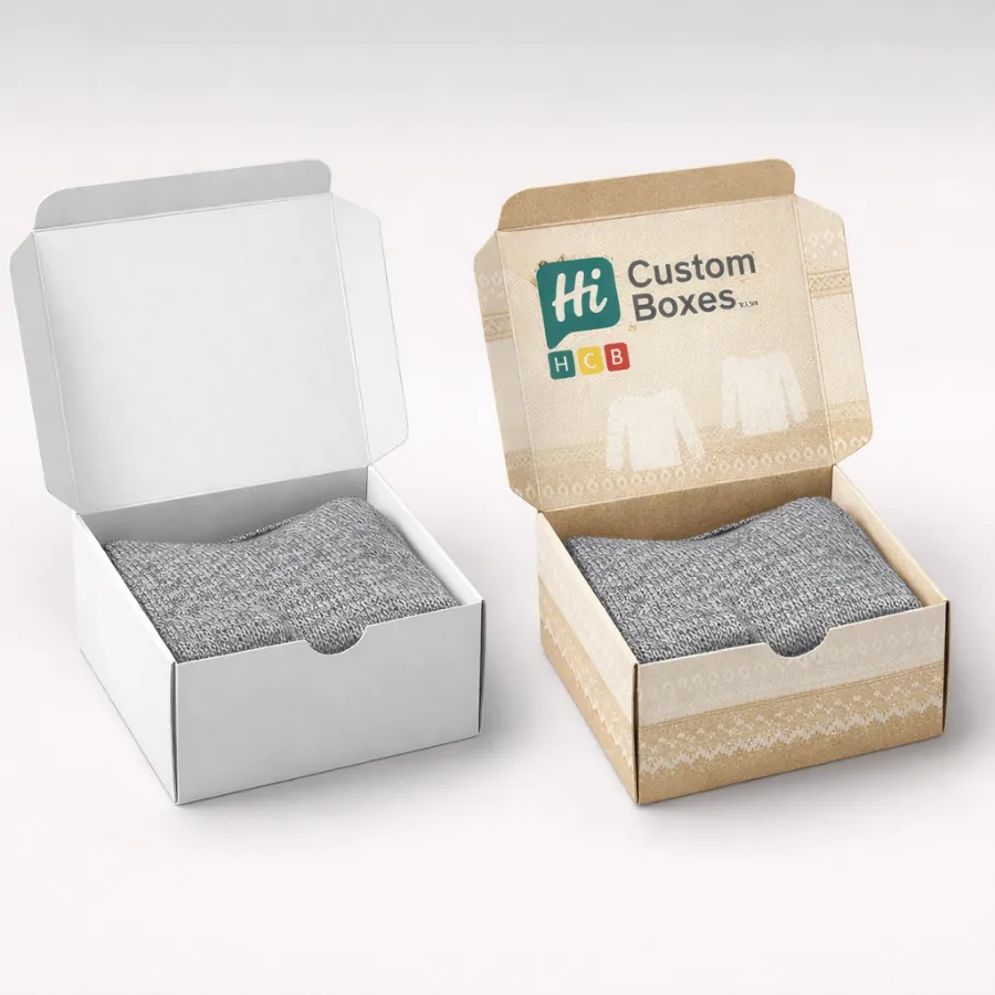 Sustainable open-top mailer boxes in white and kraft paper- displaying a grey woollen sweater inside- class=